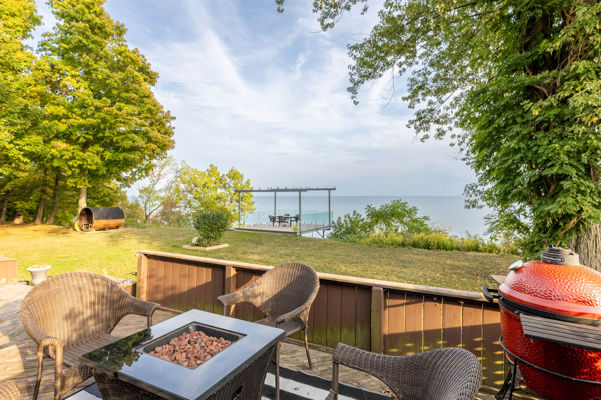 Lakefront Airbnb cottage patio with outdoor seating fire table and scenic water view